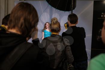 Russia, Moscow, April 12, 2019. Crocus-Expo. Exhibition photo forum for photographers. Photo models pose for photo forum participants on photo companies stands, photographers do tests