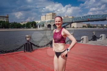 professional young female runner player running in park for training personal speed and explosive force at holiday weekend. The idea and concept of healthy lifestyle in a big city. Moscow Gorky Park