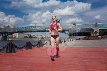 professional young female runner player running in park for training personal speed and explosive force at holiday weekend. The idea and concept of healthy lifestyle in a big city. Moscow Gorky Park