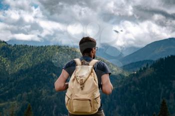 Man hiking at mountains with heavy backpack Travel Lifestyle wanderlust adventure concept summer vacations outdoor alone into the wild. Tatra National Park, Poland