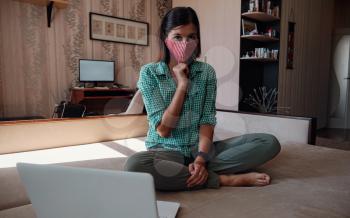 Business woman working from home wearing protective mask. Business woman in quarantine for coronavirus wearing protective mask. Working from home.