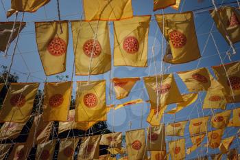 The central and ancient part of the city of Chiang Mai, Thailand. yellow flags in the blue sky, Ancient temples