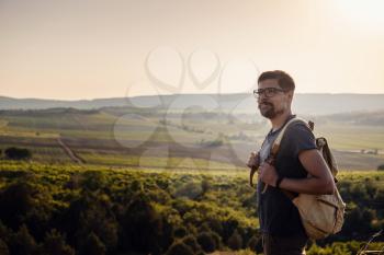 A man standing on a mountain as the sun sets. Goals and achievements concept photo composite. Concept vision, Hiker looking mountain and enjoying sunrise