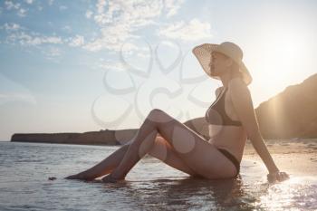 Beautiful Young Woman At Beach Wearing Hat. summer holidays, vacation, travel and people concept