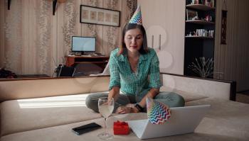 woman celebrating birthday online in quarantine time through video call virtual party. Coronavirus outbreak 2020.