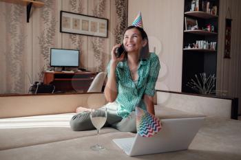 Girl celebrating birthday online in quarantine time through video call virtual party. Coronavirus outbreak 2020.