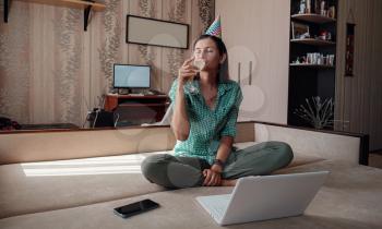 woman celebrating birthday online in quarantine time through video call virtual party. Coronavirus outbreak 2020. Woman Holding Glass of Wine
