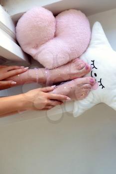 Beautiful groomed woman's feet in the socks with stars. Care about nails and clean, soft, smooth body skin. Pedicure and manicure beauty salon.