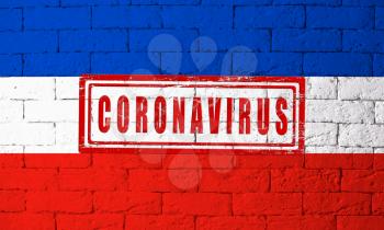 Flag of the regions of Germany Schleswig-Holstein with original proportions. stamped of Coronavirus. brick wall texture. Corona virus concept. On the verge of a COVID-19 or 2019-nCoV Pandemic.