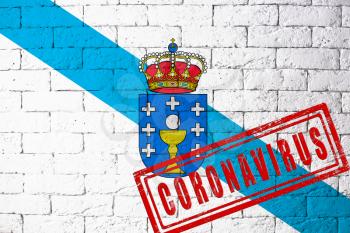 Flag of the regions or communities of Spain Galicia with original proportions. stamped of Coronavirus. brick wall texture. Corona virus concept. On the verge of a COVID-19 or 2019-nCoV Pandemic.