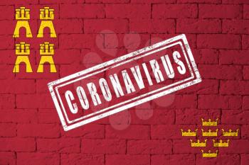 Flag of the regions or communities of Spain Murcia with original proportions. stamped of Coronavirus. brick wall texture. Corona virus concept. On the verge of a COVID-19 or 2019-nCoV Pandemic.