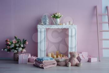 luxury clean bright white interior. a spacious room with sunlight and flowers in vases, with a decorative fireplace, cute pink plaids, and a vase with marshmallows. Idea and concept of a girl's room