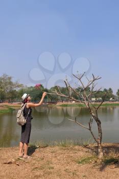 woman in Sukhothai Historical Park, a UNESCO World Heritage Site in Thailand, mobile photo