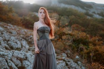beautiful furious scandinavian warrior ginger woman in grey dress with metal chain mail. Woman is a Viking. Fantasy. Book Cover