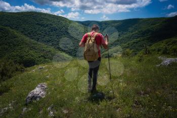 Traveler relaxing meditation with serene view mountains. Travel Lifestyle hiking concept summer vacations outdoor. Happy hiker winning reaching life goal, success, freedom and happiness, achievement