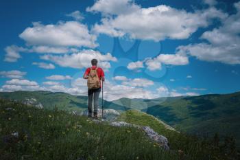 Traveler relaxing meditation with serene view mountains. Travel Lifestyle hiking concept summer vacations outdoor. Happy hiker winning reaching life goal, success, freedom and happiness, achievement