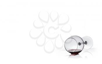 wine glass with red wine lies on glass Isolated on a white background