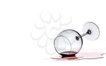 wine glass with red wine lies on glass Isolated on a white background