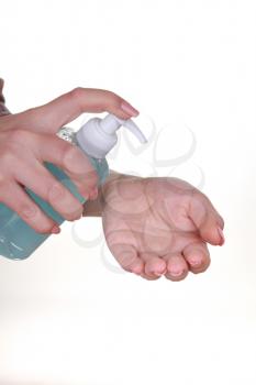 female hand holding bottle with liquid soap isolated on white background. blue alcohol cleaning gel bottle, Prevention of diseases. Covid-19. Cleaning healthy and personal hygiene.