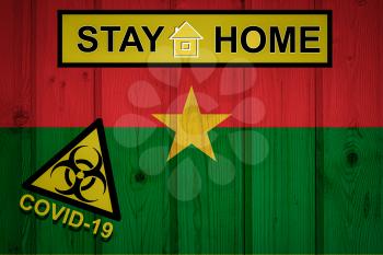 Flag of the Burkina Faso in original proportions. Quarantine and isolation - Stay at home. flag with biohazard symbol and inscription COVID-19.