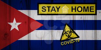 Flag of the Cuba in original proportions. Quarantine and isolation - Stay at home. flag with biohazard symbol and inscription COVID-19.