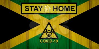 Flag of the Jamaica in original proportions. Quarantine and isolation - Stay at home. flag with biohazard symbol and inscription COVID-19.