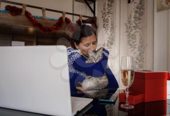 woman and cute cat enjoy celebrating and waving in party via video call conference with friends and family. Asian woman quarantine for protection coronavirus and working from home
