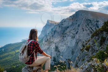 woman hiker enjoy the view at mountain peak cliff. idea of ecotourism travel. Discovery Travel Destination Concept