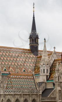 Detail of ornate carving and roof tiles on Mattias Church in Buda, Budapest, Hungary