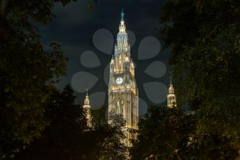 Facade of the town hall or Rathaus illuminated at night in Vienna, Austria