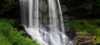 Panoramic view of Dry Falls waterfall cascading down the rocks on Mountain Water Scenic Byway near Highlands in North Carolina, USA