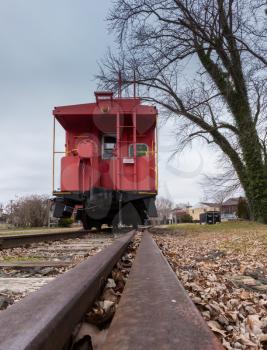 Old fashioned RR Railroad red caboose with rail leading to it in Warrenton, VA