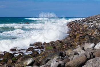 Stormy seas coming to the rocky breakwater and beach off Polihale Beach, Kauai, Hawaii