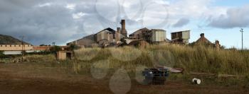 Panoramic view of old deserted sugar mill being overgrown by nature near Koloa, Kauai in Hawaii