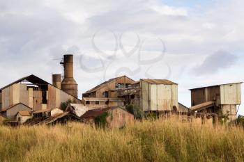 Close view of old deserted sugar mill being overgrown by nature near Koloa, Kauai in Hawaii