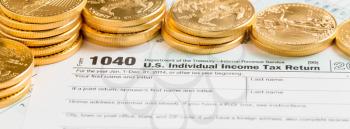 Gold coins on USA tax form 1040 for header photo on social media page of tax preparer or accountant business. Sized to fit a popular cover image placeholder.