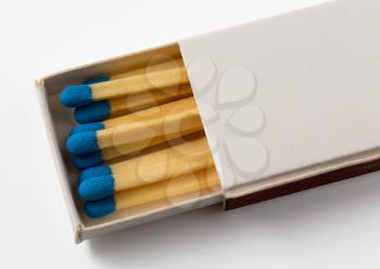 Small free hotel pack or box of matches with white background and blue tips to the match