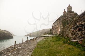 View of harbour or harbor as the mists roll in over the ocean in Port Quin, Cornwall, England, UK