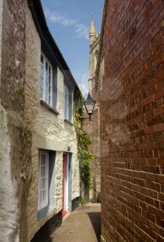 Traditional narrow path or alley leading past old houses to the parish church in Fowey, Cornwall, England, UK