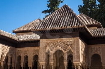 Ornate roof and pillars and arches in courtyard in Nasrid palace in Alhambra Granada, Spain