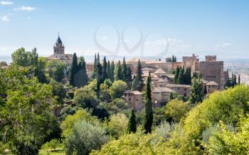 View of Nasrid Palace and church from gardens of Generalife in Alhambra in ancient city of Granada in Andalucia, Spain, Europe