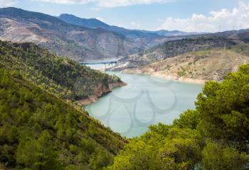 A44 autoroute or motorway crosses Rules Reservoir and RIo Guadalfeo as it runs north through Sierra Nevada Mountains in Andalucia, Spain
