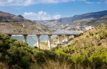 A44 autoroute or motorway crosses Rules Reservoir and RIo Guadalfeo as it runs north through Sierra Nevada Mountains in Andalucia, Spain