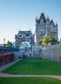 Juxtaposition of the Tower Bridge against the walls of the Tower in London, England, UK