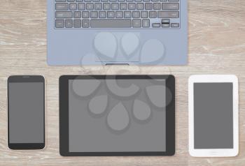 From above view of many computing and smartphone screens to illustrate the concept of responsive design or template or for use as a hero header image for website