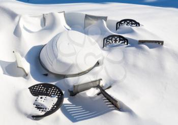 Outdoor garden table and chairs buried by snow in deep drift during blizzard of January 2016