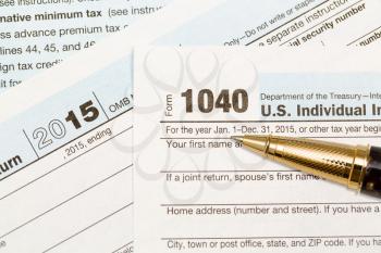 USA IRS tax form 1040 for year 2015 with ballpoint pen and taken from above