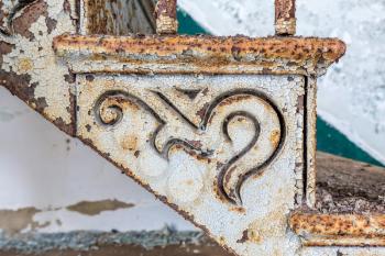 Close up detail of the shapes in the rusty paintwork of old cast iron staircase