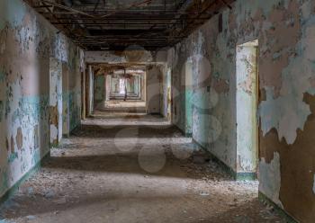Empty rooms off long corridor inside Trans-Allegheny Lunatic Asylum in Weston, West Virginia, USA