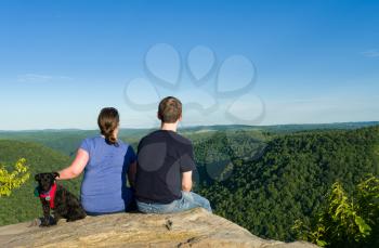 Hikers look at Cheat River Canyon from Raven Rock in Coopers Rock State Forest West Virginia